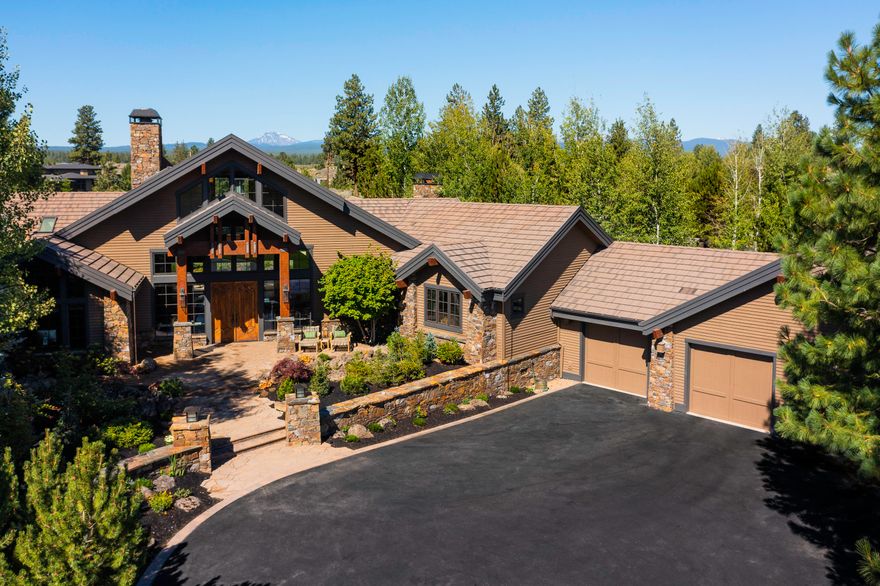 Simply stunning Northwest lodge design in the private, gated Broken Top community on Bend's favored westside & situated on the 6th fairway w/Cascade mountain views. Inviting courtyard entry highlighted by a flowing water feature & stone columns. Beautiful lush landscaping & paver patios. The expansive floorplan is all one level except for an upper level guest suite. The interior craftsmanship is apparent w/hand hewn posts & beams, dovetail & lap joints, hand troweled wall texture & 4 masonry built stone fireplaces. Walls of windows let the natural light shine through. Recently updated w/new gourmet appliances throughout, new ceiling fans & light fixtures, new Hunter Douglas automated shades, new Sonos sound system thru whole house & patio, new Arctic Spa & decking off primary suite. Special features include Elm wood floors, two wet bars, three ensuite bedrooms, back patio with firepit & waterfall, new dual HVAC system with Active Pure air purifier & custom garage cabinetry.