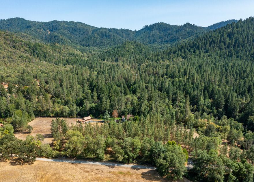 NEW PRICE! Undoubtedly one of the most comprehensive properties S. Oregon has to offer! A beautifully remodeled home perched on the banks of Evans Creek surrounded by towering pines and approximately 1,400' of creek frontage; 12.49 acres with gated access; irrigation rights; a 30 x 30 custom shop with attached 2 stall barn and a full bathroom; gorgeous landscaping and much more! The 3,005 SF home has been extensively renovated with high-end amenities including a new custom kitchen, stunning master bath, new HVAC, flooring, lighting and a utility room with a dog washing station. The home was designed with an open layout, unique architectural features and an abundance of windows to capture the outside world while showering the home with natural light. Outside you can relax and enjoy the expansive deck overlooking the creek or cozy up by the firepit. So many hard-to-find features all rolled into one turn-key property, a truly rare opportunity to make this home your own!