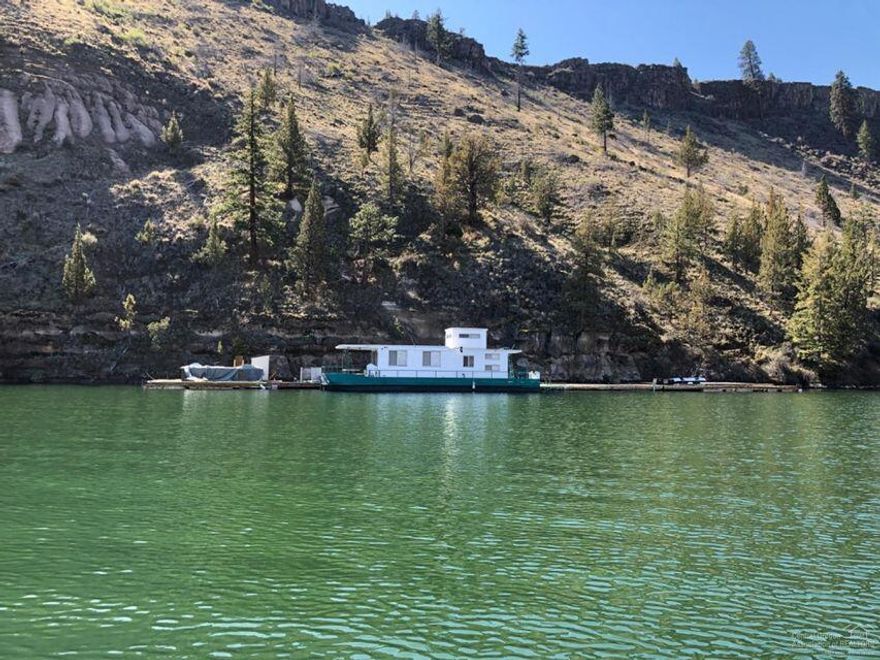 Lake front property! Located on the Metolius River arm of Lake Billy Chinook. Only accessible by boat. Huge floating dock (approx 3,000 sq.ft.) with outdoor kitchen, built in BBQ, Evo Wok, propane burners and a sink. Includes a 1979 Master Fab Houseboat which is fully furnished. It sleeps 8(rear queen bedroom, 2 queen futons, and a queen bed upstairs). There is also a few storage buildings on the dock. This property is a rare find if you want to have a lake getaway this is the place to be!