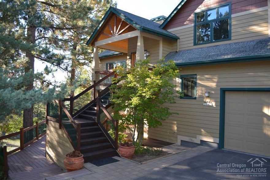 Stunning custom craftsman home w/ big easterly views. High ceilings, wood windows, solid wood doors, oak cabinets & floors, wine cellar, central vacuum, solar hot water, laundry room, huge master suite w/ soaking tub & spacious closet, study/office off master. Open kitchen, 2-sided gas fireplace for dining & living room. Attached workshop. Outdoor gas fireplace under covered portico w/ 3 spacious decks. Private on a quiet street situated on over 1/2 acre w/ many varieties of trees and flowering bushes.