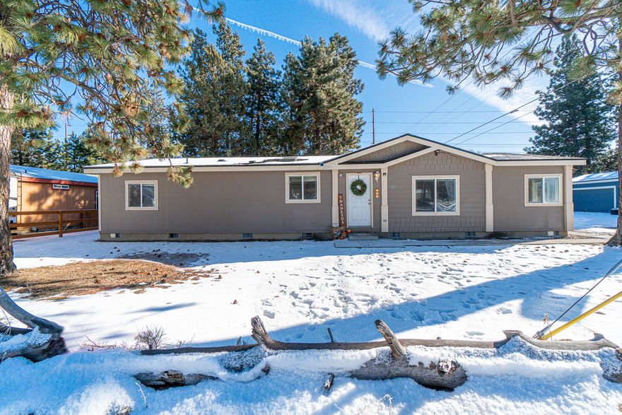 Welcome home to this adorable, updated SW Bend home on a nicely treed, very large, fully fenced lot! Spacious and welcoming, this open concept 3 bedroom, 2 bath home + bonus room/den and laundry room lives large. Generous 2 car garage + RV parking! Brand new roof in 2018, high quality attached storage shed, new back deck and patio with new awning. New oven and microwave + new luxury vinyl flooring throughout main living area. Plenty of room for all the Central Oregon toys!!