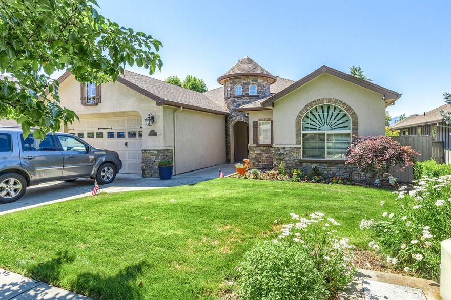 Amazing curb appeal with the first thing you will notice is the unique Turret and entry way when you drive up. High quality craftsmanship and charm w/custom finishes & fixtures throughout. High coffered ceilings, rich warm custom woods used for all doors, cabinets & vanities. Beautiful brand new laminate flooring in living areas w/carpet in 3 of 4 bedrooms (1 bedroom is being used as office). Tile in bathrooms. Large living room with rock surround w/cozy gas fireplace makes it feel like home. Wonderful kitchen w/granite countertops that opens to dining room, eating bar and there are stainless appliances & tons of cabinetry w/under cabinet lighting. Main bedroom includes tile stall shower, granite counter, jetted tub, double vanity & large closet. Slider off dining room opens to a covered patio. Easy care yard with vegetable garden & 3 budding apple trees. There is a narrow access/parking area along one side of house for a small boat or extra vehicle.