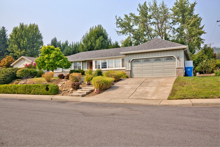 Back on the market at no fault of the property! Beautiful and spacious home!  Located on a corner lot in a quiet cul-de-sac just 1 mile from downtown Rogue River. Sunken living room with large windows to enjoy the gorgeous mountain views. Large kitchen and dining area – laundry room. 3 beds/2 baths + office/den. Split floor plan with luxurious master suite: huge walk-in closet, remodeled master bathroom, and French doors to back deck. Mature landscaping w/sprinkler system - Brand new 30-year roof on home. Close to Grants Pass, Central Point, and Medford.