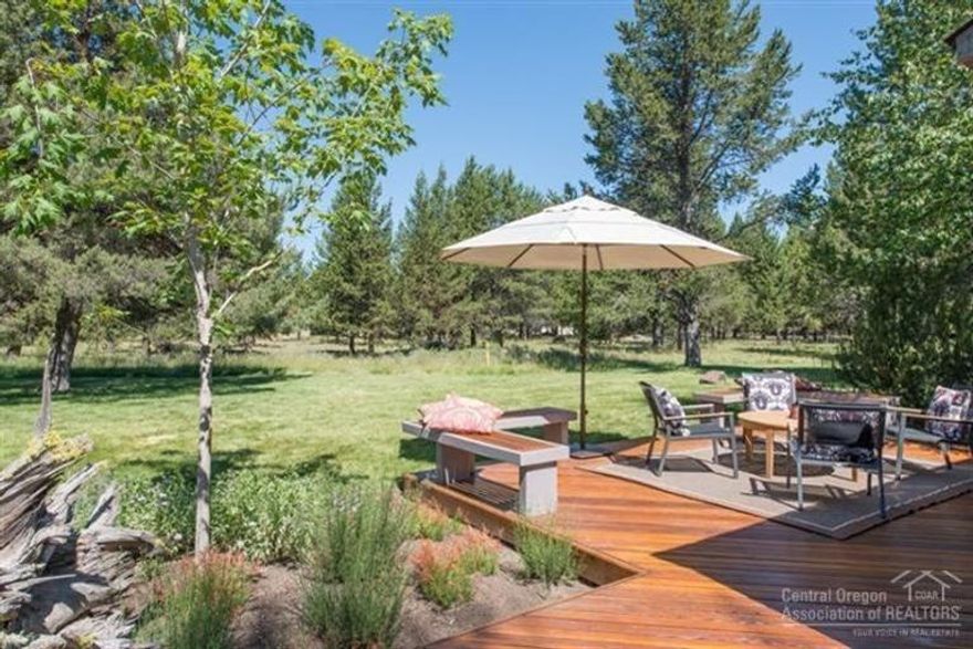 ONE OF A KIND! This beautifully updated Meadow House Condo offers the perfect blend of modern comfort & Sunriver charm. Featuring two suites, an open-concept kitchen w/ stainless appliances, an induction cooktop, & a quartz island w/ eating bar, this home is designed for effortless entertaining. Expansive Jeld-Wen windows bring in abundant natural light, creating a seamless connection to the outdoors. The inviting great room boasts a gas fireplace & overlooks the serene common area. The main-level primary suite features heated tile floors, a walk-through closet, & direct access to the bathroom. Step outside to enjoy the expansive wraparound TimberTech deck—a unique feature you won't find on other units—perfectly positioned to capture peaceful common area views. Thoughtfully added landscaping enhances this desirable end-unit condo. Additional features include tankless HWH, single-car garage, two storage areas, & A/C.  Ready for you to enjoy the best of Sunriver!