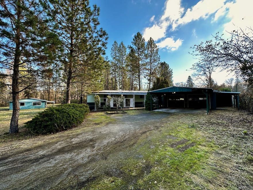 Diamond in the Rough on .93 Acres. This home has Lots of Potential, with 2 Bedrooms, 2 Baths, Large Living Room, Family Room, and Kitchen Island in 1248 Sq Ft, Covered Front & Back Porches, Detached 2 Car Garage with extra storage, and Car Port. Detached 24 x 38 Barn/Workshop. Nice Neighborhood near RCC, Shopping, and Medical. This property is Fenced and Gated, includes Irrigation Rights with Grants Pass Irrigation District, and District 7 Schools.