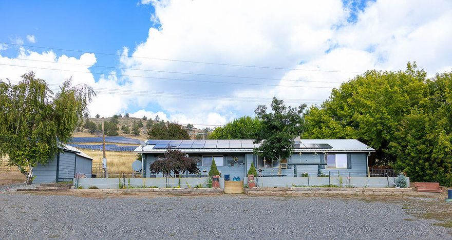 Charming 3-bedroom home on 7 acres-Horse property close to town. Don't miss the opportunity to own this beautiful-3 bedroom, 2 bath home nestled on 7 acres usable acres! Perfectly set up for horses lovers, the property includes 5 fenced pastures, horse stalls, hay storage, horse arena and plenty of room to roam. Inside, you'll find a spacious open floor plan with a desirable split-bedroom layout, ideal for privacy and functionally. Whether you're relaxing in the cozy living area or hosting friends and family, this home offers comfort and convenience in every corner. Located just minutes from town, you get the best of both worlds:peaceful country living with easy access to local amenities. Bonus a $40,000 solar system will be paid off at closing, providing long-term energy savings for the new owner. This property is a rare find and truly a must see. Inside pictures to follow.