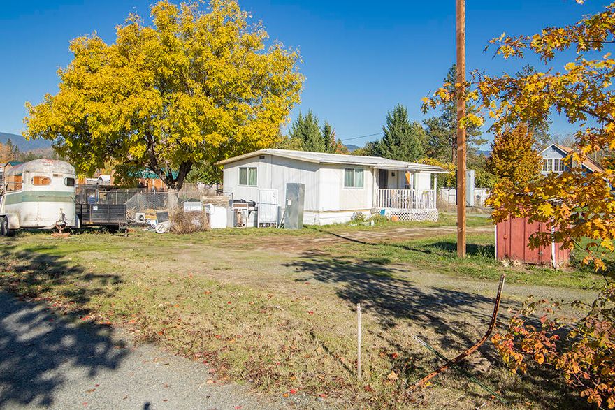 2 Bed, 1 Bath Double-Wide Manufactured Home on almost a Half Acre of Land in the Redwood Area! The Home has Extensive Interior Remodel & Upgrades, inclusive of High-Quality Laminate Flooring throughout, a New Bathroom, New Kitchen Cabinetry & Appliances, New Electrical including 200 Amp Panel, Water Heater, & a Brand New Well Pump! The Home needs Kitchen Counters installed (Estimate in hand for $1,100), & some additional Minor Finishes completed, but is Livable as-is. Excellent Parking Options here, with the Attached Carport, & RV Parking with Full Hook-ups! Nice Storage Shed Included. Enjoy Level Useable Land, with plenty of room for Kiddos & Animals. PLUS, Zoning is such that this Property can possibly be divided into Three Parcels! Recent Survey on File provides Accurate Boundaries & Corners. Pretty Mountain Views & within Walking Distance of Parks & the Rogue River! Seller will include Personal Property Items to be utilized to Complete the Minor Finish items this Home still needs.