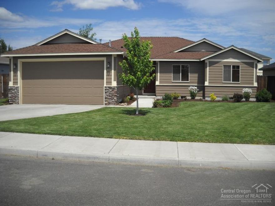 Seller is an Oregon licensed Real Estate Broker. Like new 3 bedroom 2 bath home with extras.Kitchen has added pantry cabinet-new utility room cabinets. Cement pad for RV parking area behind fully fenced back and side yards. Fireplace raised with added hearth. Garage has 2 feet added depth from standard. 8 foot garage door w/opener. Man door off garage to side yard and RV parking pad. Rain gutters over front entrance. Recirculating hot water.Back patio has gas connection for BBQ.Fully landscaped w/sprinklers