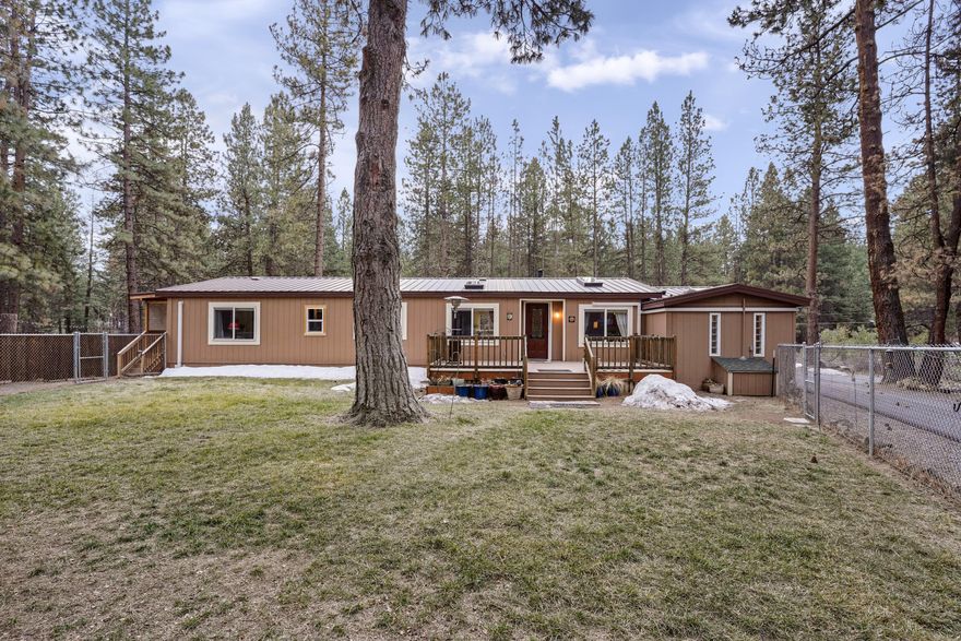 Serenity awaits you on this 1.17 acre property in Deschutes River Woods. New asphalt driveway off Baker Road leads you to a charming single-story home with 2 decks.
This spacious home has been cleverly divided into 3 separate living spaces. The main home has a large remodeled kitchen, family, dining and 2 bedrooms with a full
remodeled bathroom. 6 skylights were added to capture the natural light. There are 2 additional mother-in-law units with separate entrances. Unit 1 is a studio with full bath & kitchenette with W/D renting for $1300 per month. Light & bright second unit has living room w/ kitchenette, bedroom and full bath renting for $1500. Both units are listed on Furnished Finder for traveling nurses. Buyer to do due diligence. Heating was updated in 2018 with ductless mini splits. The fully fenced in grassy front yard is a great area to run your dogs. In the back, you will find a 2-car detached garage & newer shed. This property offers plenty of room for all your toys!