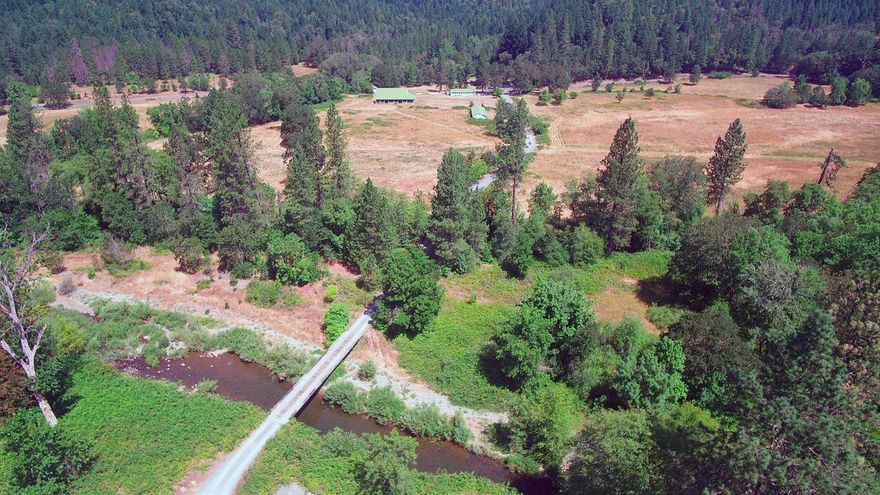 This spectacular 520-acre ranch offers endless possibilities! Included are 2 houses, 5 structures for farming activities, 200 acres of fenced pastures with water rights, timber, gold, one mile of creek frontage, 4 permanent ponds, many fruit trees and wildlife galore. During the 1930s this property had an active gold mine which produced raw gold worth tens of millions of dollars. There are 60 acres of rock and gravel with a current Oregon State land use permit. Farm the land, take advantage of the approximate 600,000 board feet of marketable timber, the $50,000 of saleable gravel or mine the gold. Not only rich in resources, it teems with wildlife; elk, deer, bear, turkeys, ducks, geese, eagles, herons & more. Four year-around ponds with bass for the fisherman's pleasure. The property also features a classic 4200 sq. ft. barn with white fenced corrals for livestock. Two bridges that span across Graves Creek provide access year-around. Don't miss this one of a kind wilderness paradise