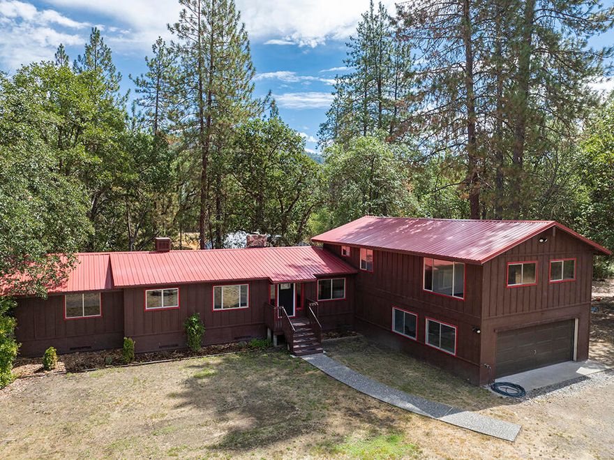 $10,000 Buyer Incentive! Motivated Seller so don't miss this one! Discover your private retreat in the heart of the Applegate Valley. Located in the vibrant Williams community, this 5.23-acre sanctuary offers peace and privacy. The 2,446 sq. ft. home features 3 beds, 2 baths, vaulted ceilings, and a stunning floor-to-ceiling rock mantle with wood stove. Recent updates include a fire-resistant metal roof, new flooring, fresh countertops, and modern fixtures. Move-in ready! Flexible layout could convert to two units, perfect for multi-generational living, a rental, or guest quarters. A third bathroom is plumbed and ready to finish. The property also includes an attached garage/shop, a 1,000 sq. ft. single-wide mobile home, storage shed, and established garden. Live close to nature while enjoying modern comfort. Owner financing available. With a $10,000 credit to help with closing costs or a rate buy-down, and a Seller ready to make a move, this is a fantastic opportunity. Come tour!