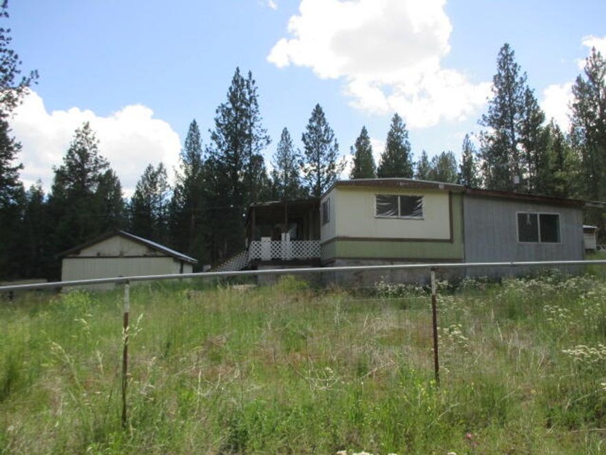 Price Reduced!  Large 1+ acre , nearly level and partially fenced.  Perfect for a garden!  Older 2BR/2BA manufactured home plus outbuildings, Has septic and well.  Please call for more details!