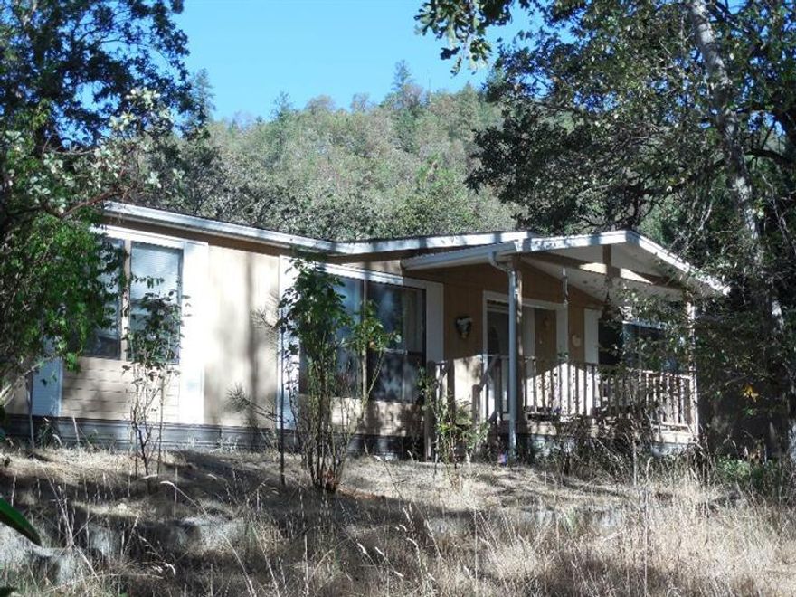 Great private rural property at the end of a county road, backed by 80 acres of BLM land and is adjacent to the back side of Pacifica. This 1.4 acres has a nice mix of mature trees that nestle this property. With a little love this could be a your next destination; the home offers 1957 sq/ft, 3 bedrooms, 2 bath, large master bedroom with two walk-in closets, a cozy living room with a gas fire place, large open kitchen - dinning area and detached 24x24 garage with breeze way. Property has many large flat areas for; animals, gardening, children to play or what ever you may want. Owner is motivated.