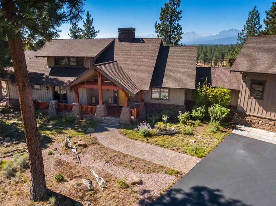 Few homes capture the essence of Central Oregon quite like this home. Your own private oasis awaits you on 18.79 acres of pristine land, scenic trails and serene high desert landscape. The minute you drive through the custom Peak-A-View gate, you will notice that no expense was spared on this stunning, custom-built home. Wake up to sunlit, snow covered panoramic views of the Cascade Mountains. Snuggle by the majestic floor-to-vaulted-ceiling wood burning fireplace featuring custom hand-cut saddle stones that were each hand placed by local masons. Chef's kitchen designed for both the home chef and entertainer alike and features Heartland appliances and Caesarstone counters. Working from home is a dream in the large home office with custom built-in bookshelves and private entry. A fully permitted and equipped one-bedroom cottage with its own entry sits above the heated 3-car garage. This legacy estate, in the greater Bend area, embraces true Central Oregon living.