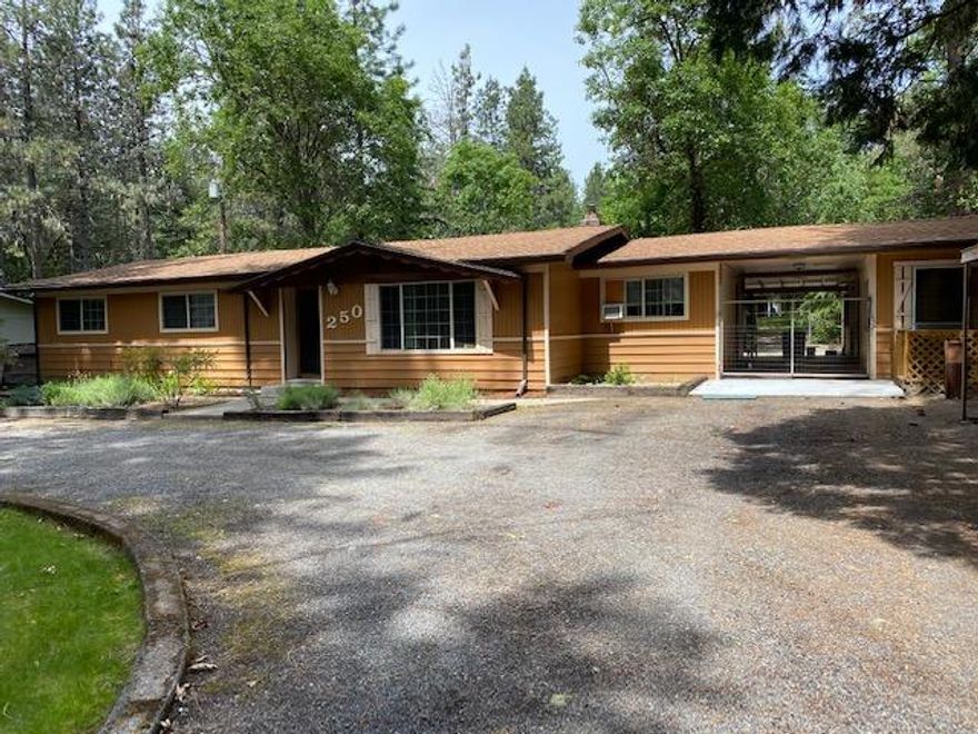 Highly desirable location provides the best of both country and city life. This is a wonderfully serene 1.38 acre, 1872 sq ft home & property just minutes from Grants Pass. Gardens, outdoor entertainment spaces, peaceful mountain views and abundance of natural scenery surrounds the gracious home. This 3 bd, 2 bath, office, sunroom, deck, greenhouse, well, septic laminate wood flooring throughout all on one level. This home has been the location for the Mug Barn (digital ceramic print shop) business for over 20 years and has separate office, storage rooms, kiln room, out buildings that are separate from the home. The home was built in 1964 and has had remodels to the main bathroom, sunroom, new flooring, new kitchen and bathroom sinks and faucets. The home has electric central air and wood stove for heating. The back yard is like a park with large garden, seasonal creek, fenced yard for your dog. Very private and quiet area that allows for a calm and serene living environment.
