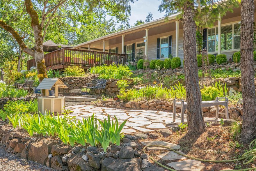 Welcome to this beautifully updated 3-bed, 2-bath ranch on 5 serene acres in Trail, Oregon. Enjoy a durable metal roof, fresh exterior paint, granite counters with reverse osmosis, and a spacious primary suite with a renovated walk-in closet, jetted tub, and separate shower. Firewise landscaping, Hardie Board siding, multiple sheds, and garden areas enhance the property. The large, permitted detached 2-car garage provides ample storage or workspace. Unwind by the seasonal pond—just minutes from Shady Cove and the Rogue River, with easy access to Ashland and Jacksonville.