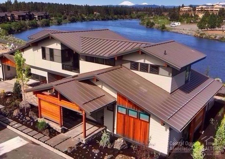 Stunning Riverfront home in the Old Mill District. Enjoy the clean lined contemporary interiors; Quarter sawn white oak flooring w/custom stain throughout, beautiful tile & stone accents with unique design elements. The well-appointed kitchen boasts generous counter space, high-end Dacor appliances, stunning backsplash accents & solid quartz countertops- all with lovely views of the patio & river. The outdoor living area w/built in BBQ & gas fireplace is perfect for indoor-outdoor entertaining.