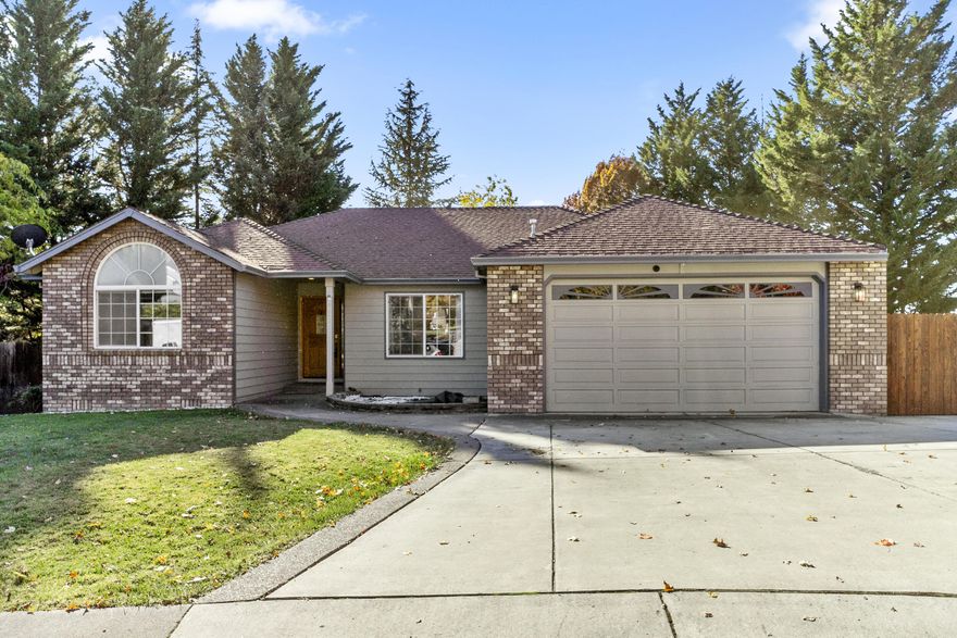 Welcome to a quiet East Medford cul-de-sac and your beautifully designed home! This spacious residence combines comfort and style, featuring an open floor plan, elegant oak doors, and custom cabinetry throughout.

Step into a bright living area with hardwood floors and a cozy gas fireplace—perfect for relaxation or gatherings. The modern kitchen is equipped with granite countertops, dark stainless steel appliances, and ample storage for effortless meal prep. The primary suite offers a walk-in closet and an en-suite bathroom with a separate shower and soaking tub for a spa-like retreat.

Outside, enjoy a fully fenced backyard with fantastic views, two decks, and a hot tub off the primary suite for added privacy. Plus, with RV parking and a double-car garage, you'll have all the space you need.

This move-in-ready home is waiting for you. Schedule your tour today!