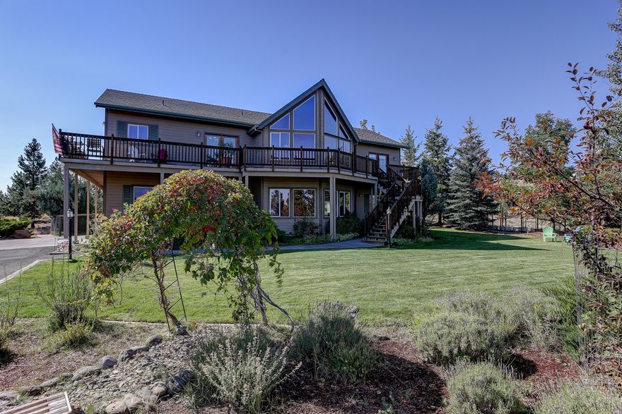 Tranquility abounds in this quiet Sundance neighborhood of SE Bend.  Hard to find 2.34 acres with ability to have horses.  Near National Forest land.  This 2539 SF 4 bdrm, 3 bath reverse living home was built in 1998. A wall of windows in the great room offers spectacular views of the Cascades and the Ochoco mountains.  South side deck offers views of the Paulinas.  Living room has vaulted pine ceilings and pellet stove w/river rock surround.  Dining and kitchen have birch floors, hickory cabinets and granite tile counters, SS appliances. Large utility room adjacent to kitchen. Primary bedroom has walk-in closet, dual vanity, jetted tub and shower.  Another bedroom and full bath complete the upper floor. The ground level has two more bedrooms, bath, large bonus room w/wet bar. Two car attached garage w/large shop/hobby area.  New roof scheduled Fall 2021. Heat pump 2018. New dishwasher.  Large fenced area.  Shed for extra equipment, fenced garden area.  Water feature, landscaped.