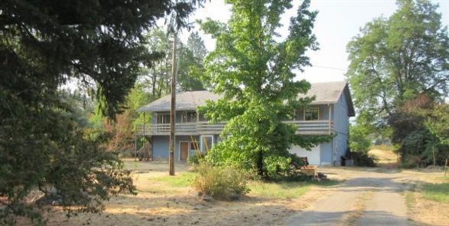 Property could be transformed into a multi-generational family estate. Country Living in Gold Hill, & short walk to the Rogue River. Home looks out over a sun drenched 3.69 acre pasture. Two story with upstairs of 2040 sq ft., 3/2 with kitchen, living room, and views. Downstairs 2040 sq ft. has the potential for adding rooms. Plus, It has a detached 1000 sq ft. storage structure. May have two family set-up potential. Many possibilities. No info on well or septic. Vacant. As-is sale. Plan a Country Christmas!