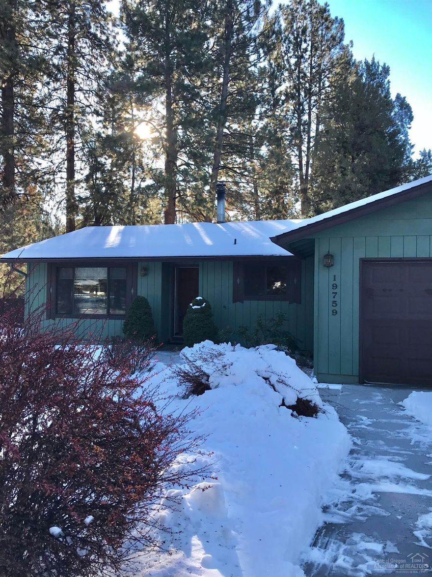 Adorable single-level SW Bend home on .96 of an acre surrounded by beautiful mature trees nestled up to your own rock berm giving character and providing privacy. 3 Bed, 2 Bath. Lots of real wood wall accents. Cozy up to the woodburning stove w/ brick surround in the heart of the living area. Kitchen is spacious w/ ample storage. Laundry room is huge--comes w/ newer Washer and Dryer. View and enjoy back deck berm through the sliding glass door while enjoying your meals. Dual pane vinyl windows, cedar exterior, 2 storage buildings and a fenced yard. Let your landscaping imagination run wild w/ this natural back yard and lovely berm. This great home is situated on a spacious and unique lot, you'll want to come see this in person. Plenty of room for toy/RV parking or consider building a shop. The Homestead Development is conveniently located near Elk Meadow Elementary and the Brookswood Plaza.Easy access to express way and just minutes to the Old Mill District.