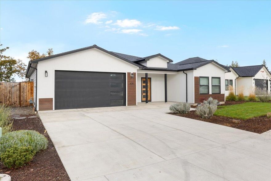 3 bed + Office 2.5 bath 1856 SQFT home on a large .36 Ac lot built in 2022. Inside you will find an open layout with a split floor plan.  The spacious entryway opens into the large living area with 9' ceilings, laminate flooring, and black Anderson windows. The kitchen features include a center island with stone countertops, a full-sized farm sink, electric oven, gas range combo, dishwasher, and sizable pantry space. The master bedroom features a walk-in closet, double vanity and private toilet area. The finished 2 car garage is wired for an electric car charging port/welder and is Solar ready.