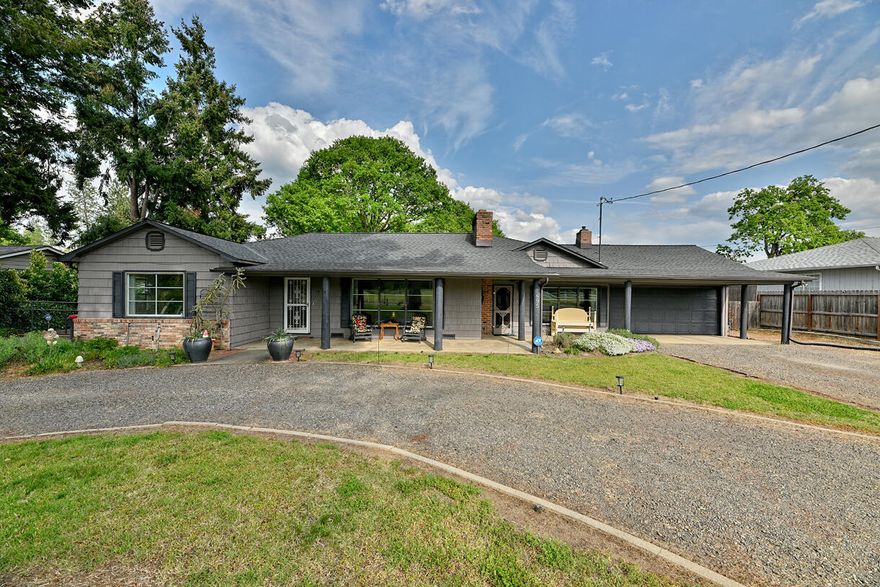 Peaceful living in a prime location! This small-acreage property is tucked away on a private drive, offering both privacy and convenience. Featuring a remodeled kitchen, spacious family and living rooms, and a versatile shop, this home is designed for comfort and functionality. The family room and living room both feature a fireplace for cozy evenings on winter days. Spacious bedrooms with nice natural light. Dining area/sunroom has a ton of windows, allowing the light and views to pour in. Backyard features built-in bbq, great for entertaining. Lap pool is an added bonus for exercise or just cooling down on warm days. Extensive large raised garden beds will allow you to grow an extensive crop of your choosing,  Enjoy breathtaking views and the tranquility of country living—all just minutes from town. A rare opportunity in a highly desirable area!