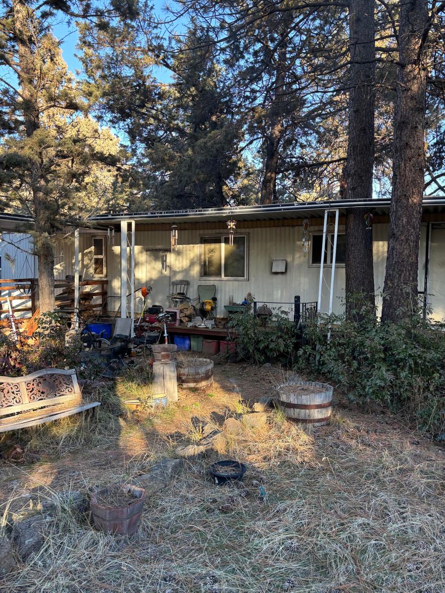 This 1977 manufactured home has out lived its useful life. Home is not available for viewing. This is for the beautiful, flat, .34 acre lot, steps to the Deschutes River in Woodriver Village. From this location, it is possible to take a watercraft to the river and float to hear music in the Old Mill. Drone footage coming soon. Home is on Avion water and City Sewer.