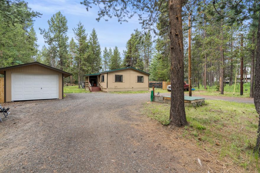 Tucked in the mature pines between Sunriver Resort and Mt. Bachelor sits this private 0.49 acre lot and home minutes from world class fly fishing, hiking, Mt Bachelor & the high lakes. Home is situated just off a quiet paved road w/ plenty of room for all your toys & adventure rigs. Covered front porch leads to a great room layout w/a main living area featuring a wood burning stove. Carpeted living room opens to the kitchen area which is adorned w/laminate flooring. Kitchen has all appliances included & eating area. Two bedrooms & one full bath as well as laundry room that leads outside to a large backyard area w/woodshed + additional storage. Detached carport has been configured to serve as your own personal workshop! Come make this house your home or transform into your vacation getaway!