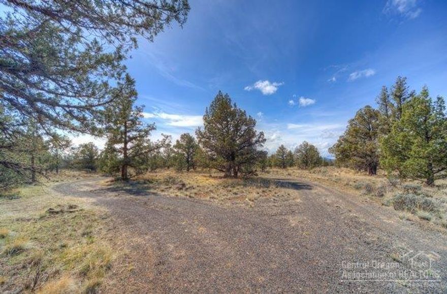 Rare Find! This elevated lot could provide stunning westerly, Cascade views w/removal of a few trees. It is adjacent to public land and a short walk to stunning river views. Lovely storage building, plus septic & capped-well installed and there are many building sites. A perfect place to build your dream home where you can enjoy tranquility with the notorious Deschutes River nearby. Hike down to the Deschutes & enjoy some of the best fishing this side of the Mississippi, along with all the CRR amenities.