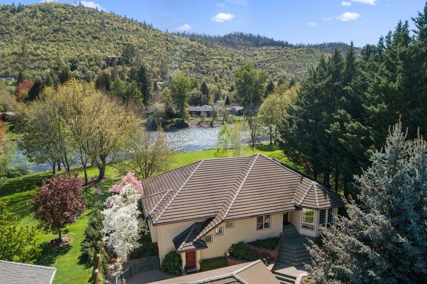 Stunning home with over 100ft of river frontage! DO NOT MISS OUT! The home's main level is 2,870 SqFt and the basement level is 2,800 SqFt! Main level features 3 beds and 2 baths plus an office. The daylight basement features an additional 2 bedrooms,1 bath, a workshop, storage space and even more room for storage or activities. As you enter the home you'll notice the attention to detail and craftsmanship. This home has had extensive remodeling in the last five years, the kitchen has granite countertops, double ovens, and top of the line appliances. The master bedroom features sliding glass doors that lead out to the deck overlooking the river and the luxurious bathroom contains a beautiful marble floor, shower and countertops. The property is immaculately landscaped and feels like a park. Too much to put in a few short sentences! You won't regret coming to take a look at this river property!