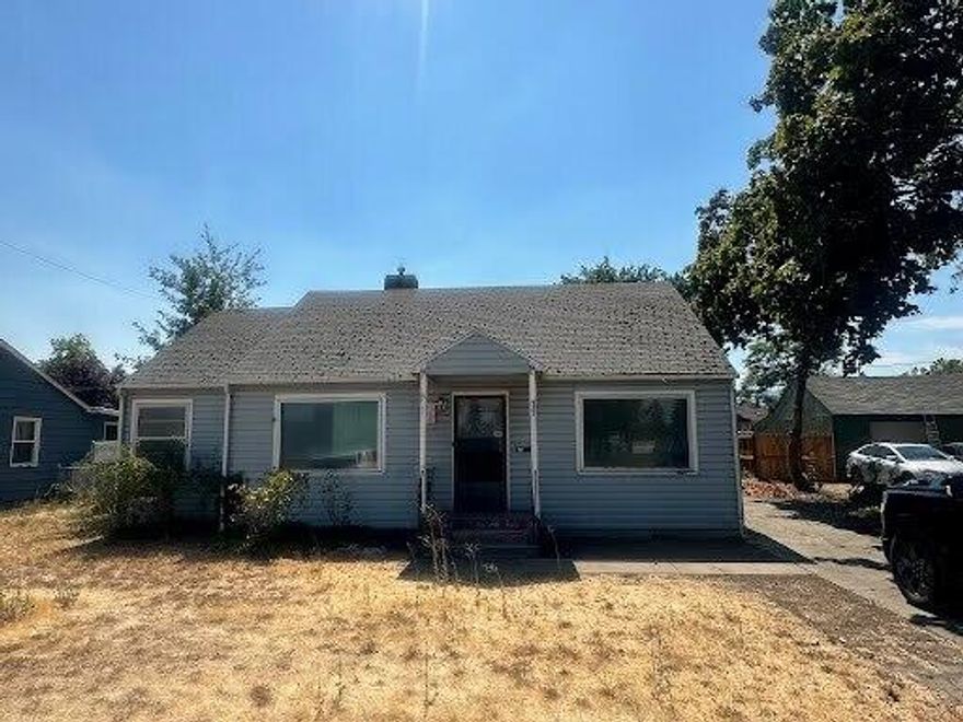 Great opportunity directly across from Washington Elementary. Huge lot, believed to be the 2nd largest on the street, fully fenced with alley access, RV parking, and detached garage/shop with back entry. Home features hardwood floors throughout most of the house, a gas fireplace, ceiling fan, and natural gas oven in kitchen. Seller priced for immediate sale, offering strong potential for a flipper or buyer looking to update and add value. With possible room for an additional dwelling (buyer to do due diligence), this property provides space, convenience, and tremendous upside. Completely fenced backyard with a private gate, allowing you to bring cars in and out from the alley. Vacant and ready to go.