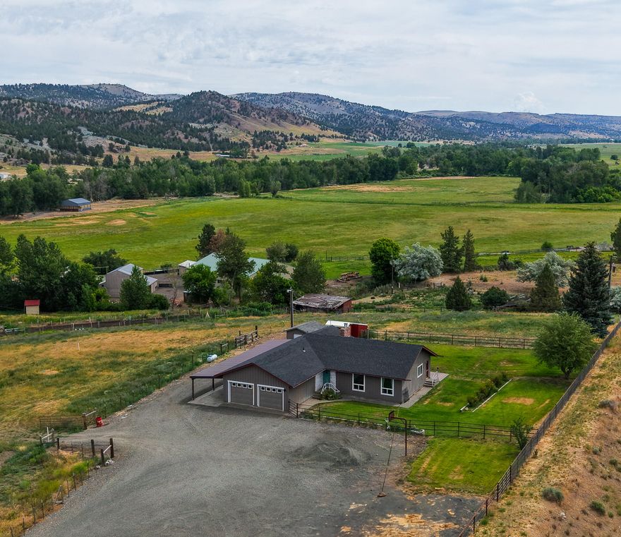 If you're searching for a property to accommodate your horses, consider this 3.51-acre parcel with 2.8 acres of water rights. Most of the property is enclosed with pipe fencing, while the rest is secured with barbed wire. The pasture features a mix of alfalfa and grass. 

The residence provides 2,790 sq ft of living space. The primary suite includes a walk-in closet, a designated makeup area, and a new tile shower. The main bathroom boasts a new deep tub and shower combination. The living room features a vaulted ceiling with wooden beams and a propane fireplace. The entire house is heated and cooled with a heat pump, and a composite roof was installed around 2020.

Outside, a lovely composition deck includes a cut-out and wiring for a hot tub. The fenced yard has underground sprinklers, rose bushes & fruit trees. The water supply comes from a spring with a 1,500-gallon concrete cistern, and a well is being connected to a 2,500-gallon cistern.