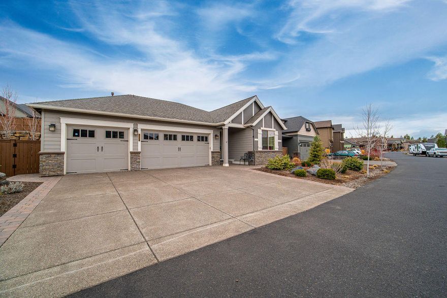 This thoughtfully designed single level home with a 3 car garage is anything but typical for Pahlisch. With a lengthy list of upgrades the owners have created a stunning & comfortable abode with entertaining in mind. Deep, rich wood floors & gallery style entry with coffered ceilings lead you to an open concept great room with vaulted ceilings & picture windows that fill the space with southern exposure sunlight. The windows have automatic banded blinds for sun shade. A huge quartz topped island that seats five is centered in a well appointed kitchen with SS appliances & loads of cabinets equipped with pull out shelves. A focal point is the custom wet bar with a classic wine barrel sink & automatic clear party ice maker, perfect for entertaining. With better weather, move outdoors to the covered patio to enjoy the private backyard with xeriscape, a water feature & gas burning fire pit to enjoy all year. Coupled with the extensive amenities The Bridges offers, it's resort-like living.