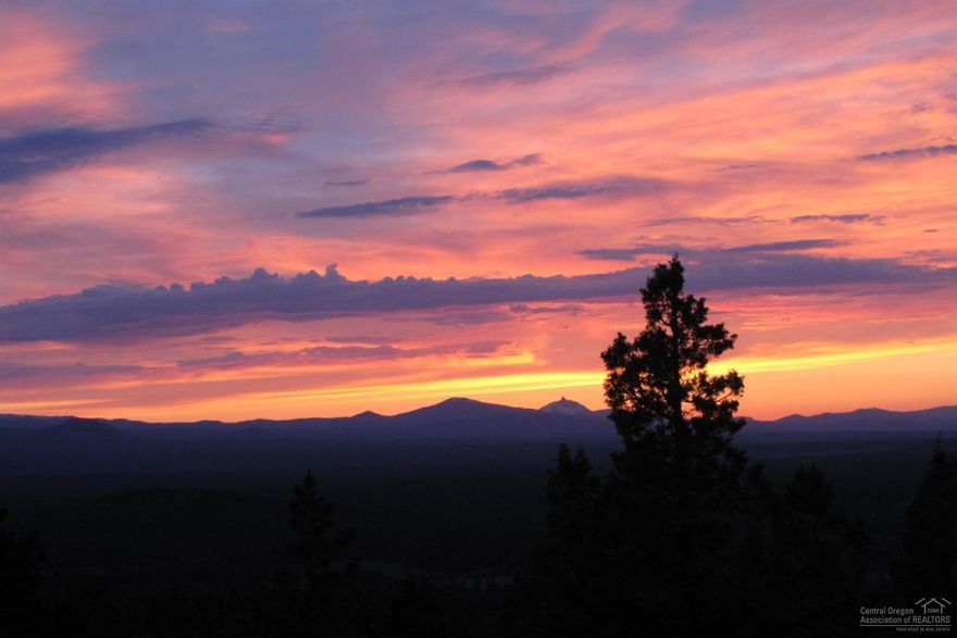 Relish the 270 degree views from this luxury Awbrey Butte home. A flat driveway leads to main floor living with master & office on the main and 3 bedrooms & bonus room in the walk-out lower level. The gourmet kitchen overlooks the open great room and out to the expansive deck you'll love for entertaining or just watching the sunset. Choose from casual or formal dining. Look out to the Cascade Mountains or over to Smith Rock from the impressive master suite - you'll never get enough of these views!