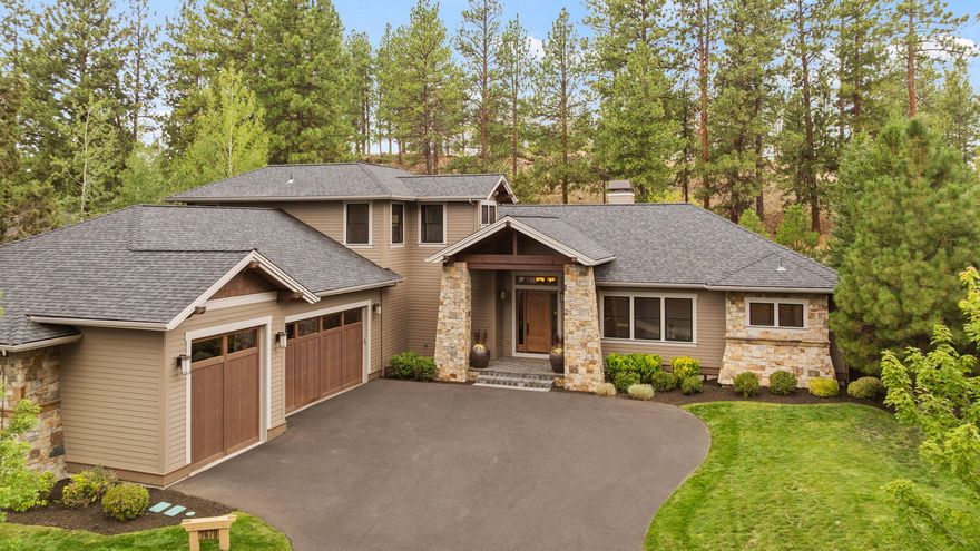 Located on a quiet cul-de-sac in SW Bend, this custom home offers a seamless blend of luxury and comfort. The main-level primary suite features a spa-like bath with a shower TV, a spacious walk-in closet with laundry hookups, and an adjacent office for quiet work or retreat. Rich wood-wrapped windows, custom metalwork, built-ins, and a wood burning fireplace with dramatic floor-to-ceiling stone surround — anchor the great room with warmth and character. The chef's kitchen is made for entertaining, with a wet bar, wine fridge, ice maker, island, and oversized eating bar. A Crestron home automation system manages lighting, built in speakers and HVAC. Upstairs, two bedrooms, a full bath, and a loft offer flexible space. Outside, enjoy a private backyard with built-in BBQ and bar area with outdoor TV.  The oversized 3-car garage includes golf cart bay and roll-up door to the back patio. Fresh interior and exterior paint, plus new carpet, complete the package.