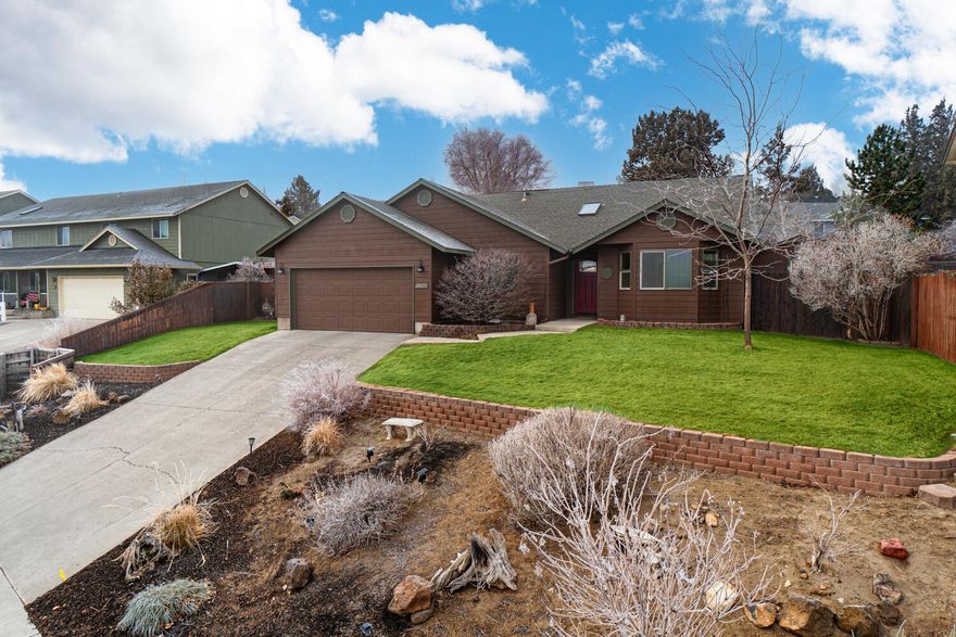 Situated in SW Redmond in a quiet neighborhood, this home offers craftsmanship & thoughtful design throughout. Enjoy city lights & views of Smith Rock! Tile entry leads to spacious living area w/ Great Room layout. Hardwood flooring throughout main living + 3rd bedroom/office & carpet in the primary + 2nd bedroom (lighter wood flooring to be replaced in photo w/ new carpet). Large Kitchen ftrs breakfast bar, plenty of prep space & storage, SS farm sink, gas range & dishwasher, pantry w/space for all your extras. Two eating areas off the kitchen w/ double doors that lead to the back patio! Primary bedroom ftrs walk in closet & full bath w/ dual vanities. Two additional guestrooms share a full bath, one is located off the entryway & could serve as an office space as well! Gas forced air, new paint, craftsman style molding throughout, & house plumbed for a generator! Fully fenced & landscaped, covered patio + storage shed out back! Just min from Umatilla Sports Complex & Valleyview Park