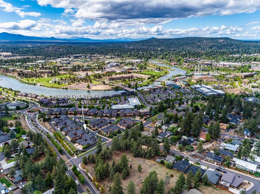 Location! Location! Location! This lovely, like new, barely lived in Townhome sits right above Bend's highly desirable Old Mill District, the Deschutes River & the Les Schwab Ampetheatre. You will love the ease of living in this 3 bedroom, 3 full bath, low maintenance home. Live full time, or enjoy a second home with little worry or preparation needed as you come & go. Property features incl SS appliances, granite counters, beautiful maple wood cabinetry & floors, tile baths, A/C, gas fireplace, plenty of storage, 10' ceilings, multiple dining areas & patios, 2 en-suite bedrooms upstairs w/ vaults, peek-a-boo mtn views, and a bed & full ba on the main level. Additional features incl a fenced back yard, 2 car garage, and HOA landscape & exterior maintenance. This location truly can't be beat. Located on the way to Mt. Bachelor, & is right in the heart of the Old Mill District where you can enjoy a float along the river, amazing hiking trails, parks, shops, concerts, dining & much more!