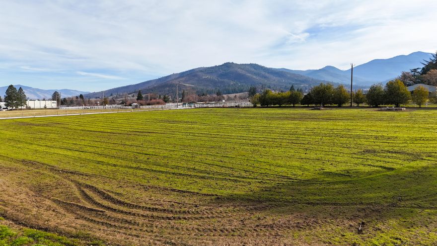 Beautiful flat, square acreage that is close to town and has panoramic mountain views.  There is a high producing well that used to be the city well for Talent plus has TID water rights.  Zoned RR-5 which allows a home to be built.  City services are also available.  This is a very unique property and is a must see.  Listing agent is related to the sellers