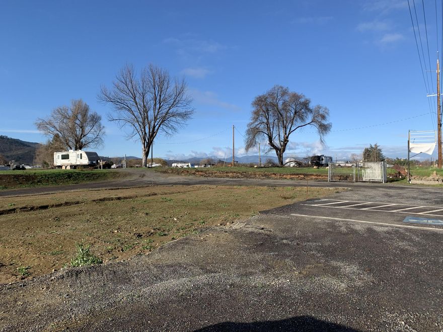 Vacant lot on .81 of an acre in Phoenix on South Pacific Hwy.  Zoning is RR-5 and rare along this road. Temp Power 100 amp installed, has a well and is connected to Rogue Valley Sewer. Also has TID irrigation rights. Could be great for many uses to a buyer. Check with the City of Phoenix for uses, previously a local business for many years that was destroyed in fire. Buyer to perform own due diligence on zoning, permits, uses etc.