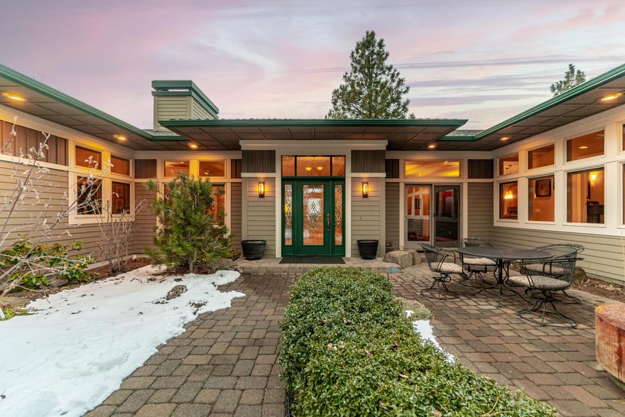 Timeless and elegant, this quality built and meticulously maintained
NW contemporary custom home is light, bright and spacious with
stunning panoramic mountain views and beautiful outdoor spaces.
Enter through a garden like, fully enclosed courtyard to an open great
room w/gas fireplace and dining area that leads to a covered outdoor
deck for relaxing, entertaining and soaking in the mountain views.
Main floor incudes a gourmet kitchen with custom cabinetry. Primary
Suite w/luxury bath, walk in closet and private courtyard. North wing
features a dedicated office w/ built ins and guest suite for a nice
separation of space. Two separate staircases access a
huge finished daylight basement that features an additional Primary
Suite with living area, bed and bath, dedicated office/bonus room and an
addt'l recreation space with outdoor access. Three car garage.
Wonderful opportunities for multigenerational living. Fabulous
Awbrey Butte location near excellent schools, shopping and medical.