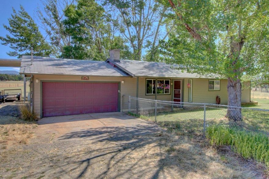 Enjoy incredible views of Mt. Mclaughlin from this 7.39 acre EFU zoned ranch. This is a horse lovers dream. This ranch offers an 8 stall breezeway barn with Barn Master doors, rubber mats, and a tac room. This property also features a covered run in shelter, round pen and the entire property is cross fenced. The 1140 sqft home features 3 bedrooms, 1.5 baths, a gorgeous brick stove with a wood burning insert, new tile, paint, flooring, windows and a new hvac system with new ducting. Enjoy endless views on the charming back covered patio or relax in the hot tub. The two car garage has lots of built ins for all of your storage needs with partial RV hook ups. This property also has a new well pump. Don't miss this opportunity to fulfill your ranching dreams.