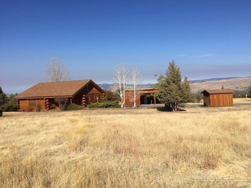 Picturesque Log Home On 4 Acres w/Panoramic Views! Pride of ownership with attention to detail in a very peaceful setting, open floor plan w/wood beams, vaulted ceiling & loft, 2156 sq ft, large kitchen features appliances, pantry cupboards & dining area, living room w/view windows, 3 bedroom, 2 bath, utility room, heat pump, carpet & vinyl flooring, shingle roof w/gutters, large covered front entry deck w/views of the mts, expansive view deck in the back overlooking the valley, landscaped, gravel driveway, board & batten storage shed, nice large board & batten workshop w/attached 2 bays for covered parking or livestock shelter. $289,000 #971