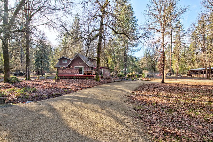 Beautiful Fairy Tale Cottage in Southern Oregon.  Updated 3 bed 2 bath chalet with charm throughout on 5.21 level private acres set up for the equine enthusiast. Kitchen and bathrooms have been recently remodeled with granite countertops, updated fixtures, plush carpet, tiled bathrooms and a clawfoot tub for a luxurious soak. Updated vinyl windows that let the outside in, exposed wood beamed cathedral ceiling in living room, large multi level deck, Master suite on lower level. Large barn with 4 + horse stalls, hay storage, tack room w/ concrete floor, room to park lots of toys, and covered runs off the back. 60'x96' pipe panel paddock with all-weather footing and an approximately 148' x 166' arena set up for roping complete with chute and box. Perimeter and cross fenced with automatic gate, detached 2 car garage/shop, Koi pond, circular drive, low maintenance landscaping, chicken coup, and so much more. High Speed Spectrum internet available.
