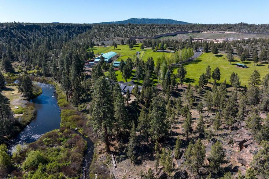 Tailwind Farm is an beautiful equestrian estate overlooking the Deschutes River in Tumalo. This home captures the river views from nearly every room and deck. The home was remodeled in 2023, has an open floorpan, 3,234 sq ft, 3 bedrooms, 3 bathrooms, living room with gas fireplace, chef's kitchen, office and attached two car garage. Property is 61 acres with 13.4 acres of water rights with sprinkler system for pastures and mature landscaping creating a private park like setting. Facility includes: 8 horse barn with tack room, indoor arena with workshop, nine paddocks, Eurowalker, half-mile exercise track, trail system, garden, greenhouse and legal 2nd dwelling 1364 sq ft, 3 beds, 2 baths. Property has a trail and easy access to the river, fenced, gated and 5 minutes from Bend.