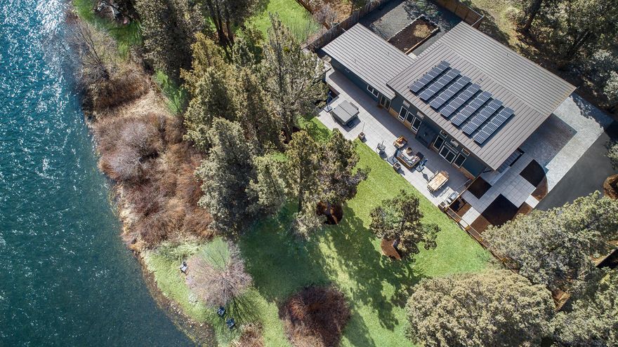 Incredibly rare .55 acre lot with Deschutes River Frontage! This recently completed new construction single level home features high end designer finishes throughout. Modern and contemporary style with a park-like setting. Great room floor plan, radiant heat concrete floors, 2 bedrooms, 2 bath plus office and utility room. Luxury kitchen with Sub-Zero Refrigerator, Wolf Range and Cove Dishwasher. Vaulted ceilings and massive triple glaze view windows!  Large new blacktop driveway with tons of parking and extra pad for your sprinter van or RV. Hookup and dump station ready to go! Mature landscaping, private setting, river views, large paver patio, multi-purpose office or yoga studio, raised beds and fenced yard area for pets. This home has state of the art Solar Panels. Ready for chickens, a  garden and room to build a large shop. Don't miss this opportunity to have direct Deschutes River access from your own backyard!