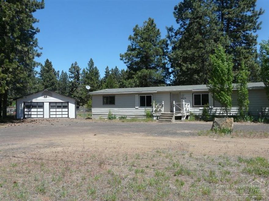 Great rural area close to town minutes away from the Old Mill district, shopping, theaters and on a paved street. Large nicely built with over half of the home renovated. It offers a 3 bedroom w/bedroom segregation, 2 full baths, bonus room and office area. Deck in back and a detached 2 car garage/shop. There is plenty of space between you and your neighbors. Property totally fenced for kids & pets. A circular driveway and tons of room for all your toys. Shared Well