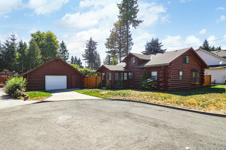 Click On Vtour For 3D Walkthrough. Thoroughly Updated light-filled Log Home On Over 1/4 Acre Lot. Pass-through garage! Acacia hardwood floors on main. Spacious living room w updated fireplace. Granite counter & exterior door to back deck, kitchen opens to dining. 2 generous bedrooms on main. Solid walnut staircase. upper level features 2 spacious bedrooms w oak floors & walk-in closets & half-bath. Fenced backyard features covered deck, extensive 20k garden, playground, gas hookup patio & more! Home Energy Score : 7