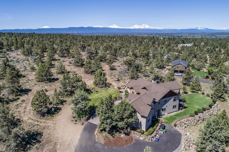 Panoramic Cascade Mountain to Smith Rock views from most rooms in this exquisite NW craftsman estate situated on 3 private acres adjacent to 120 acres of public land in Tumalo. No detail was spared in this retreat: 4 Bedroom, 4 Full Bath, Media Room/Bonus Suite, Family Room w/12' projection screen & wet bar, wine cellar, multiple outdoor living spaces, 1200 sf detached shop, RV parking w/full hookups. Entertain year around inside or out! Attached 3car oversized garage AND 3car detached shop.