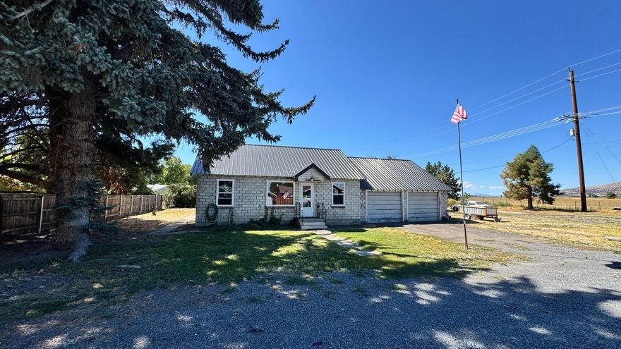 Live here and make the improvements as you go - Some remodeling has been completed! Nice tall ceilings, Propane heat & the original hardwood floors are ready to be refinished. The floorplan offers a good size living area and a dining room. All new vinyl windows and New metal roof. Covered Patio in rear of home. Nice sized parcel includes two lots totaling .40 acre. Plus there is an attached oversized 2 car garage with a cold storage room. RV Hookups in back of property. Just off Hwy 39- Easy egress and ingress for a Semi -Truck w/ trailer or large equipment. Conveniently located in the quaint little town of Merrill, Or.